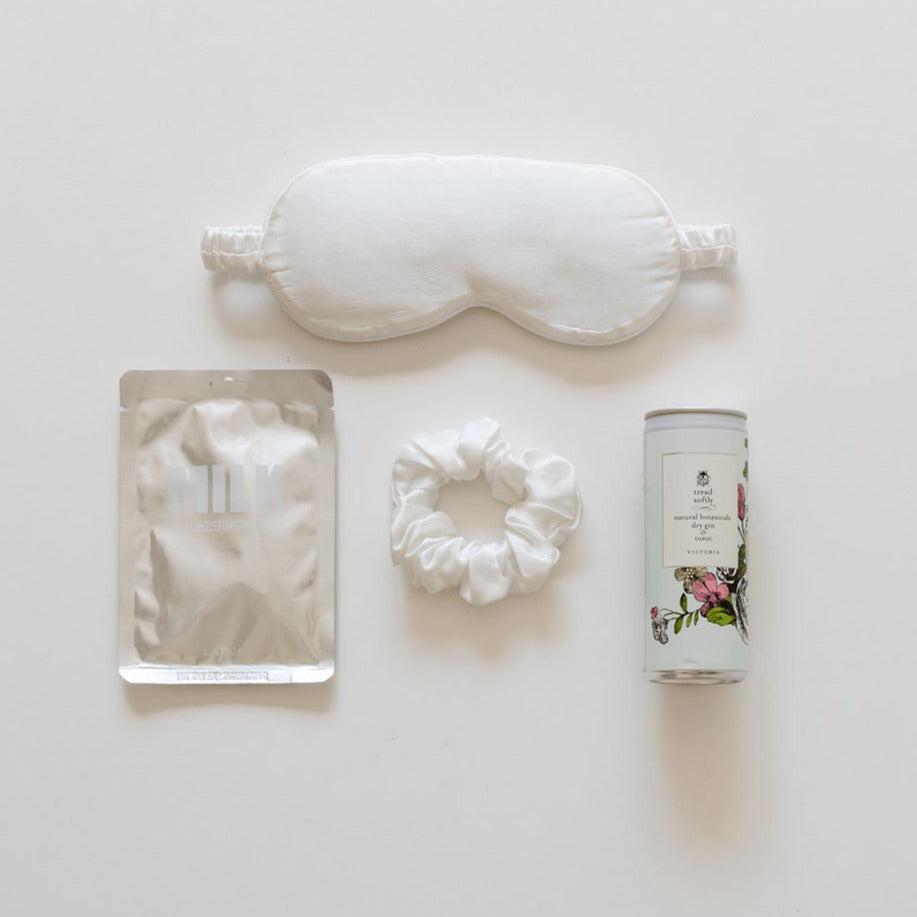 A little bridesmaid gift by biglittlegifting, eye mask, and other items on a white surface.