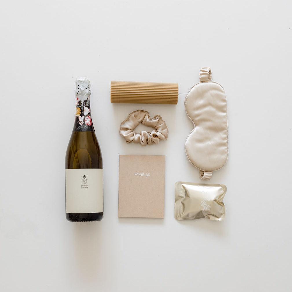 A bottle of all for you champagne and other items are laid out on a white surface. (brand name: biglittlegifting)