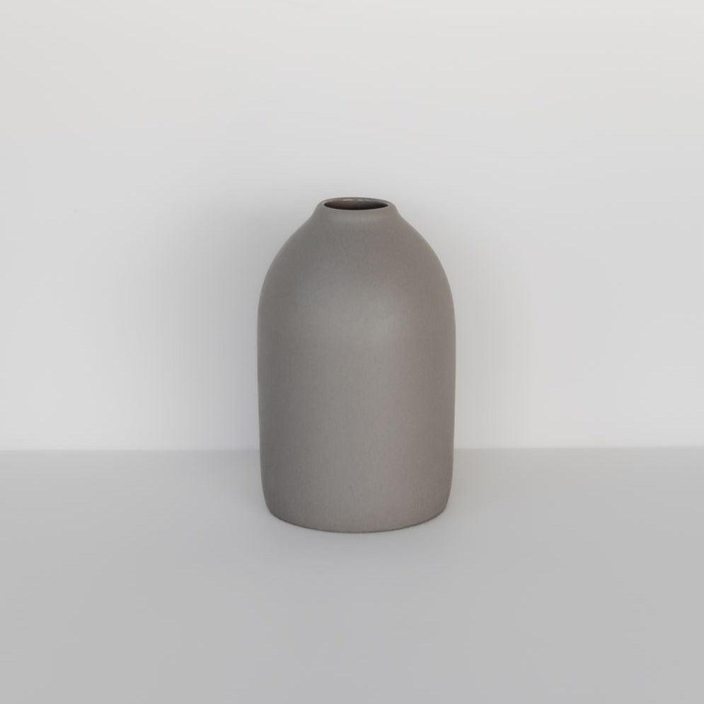 A simple dove grey waterproof ceramic cocoon vase from Marmoset Found with a smooth finish, displayed isolated against a plain white background.
