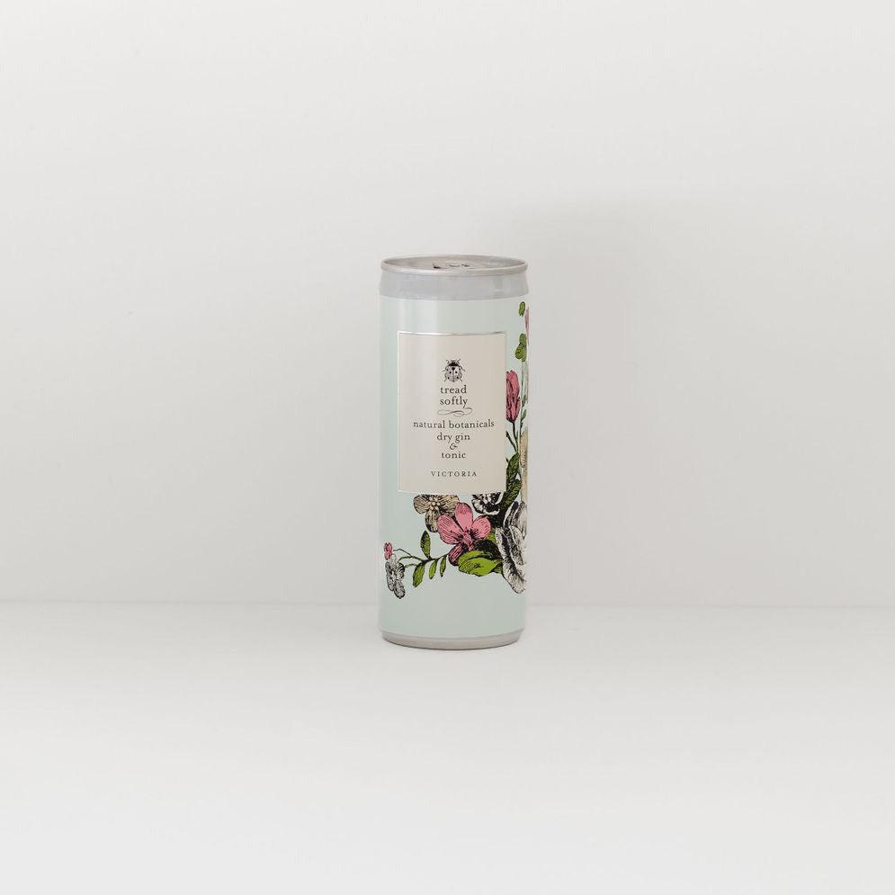 A cylindrical tea canister with tread softly | botanical dry gin & tonic designs on a white background by Tread Softly.