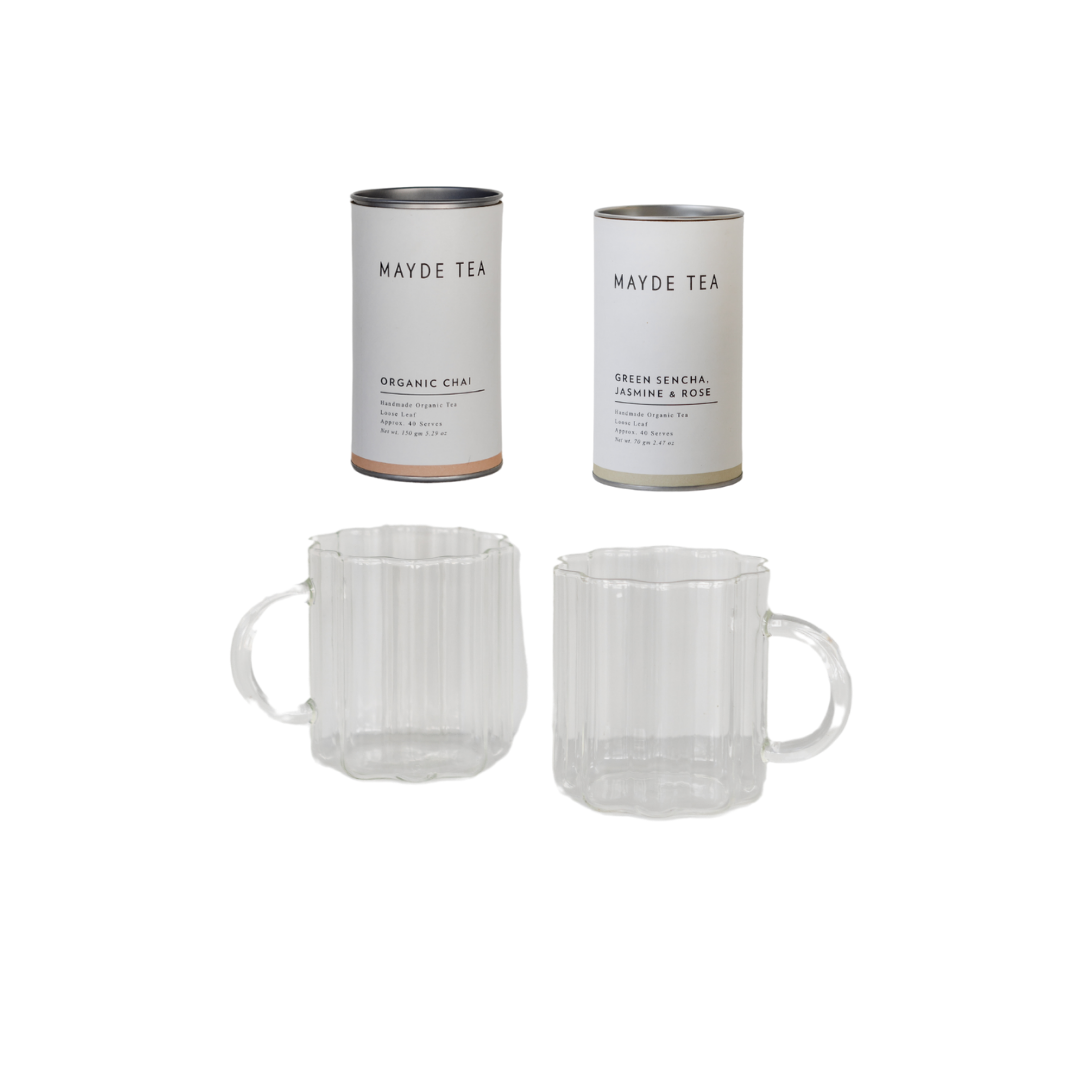 Two clear glass mugs arranged side by side beneath two tea canisters labeled "Mayde Tea" with flavors "Organic Chai" and "Green Sencha Jasmine & Rose," featured in the Ky Gifting - Curated for teams of 2 (non alc) collection by biglittlegifting.