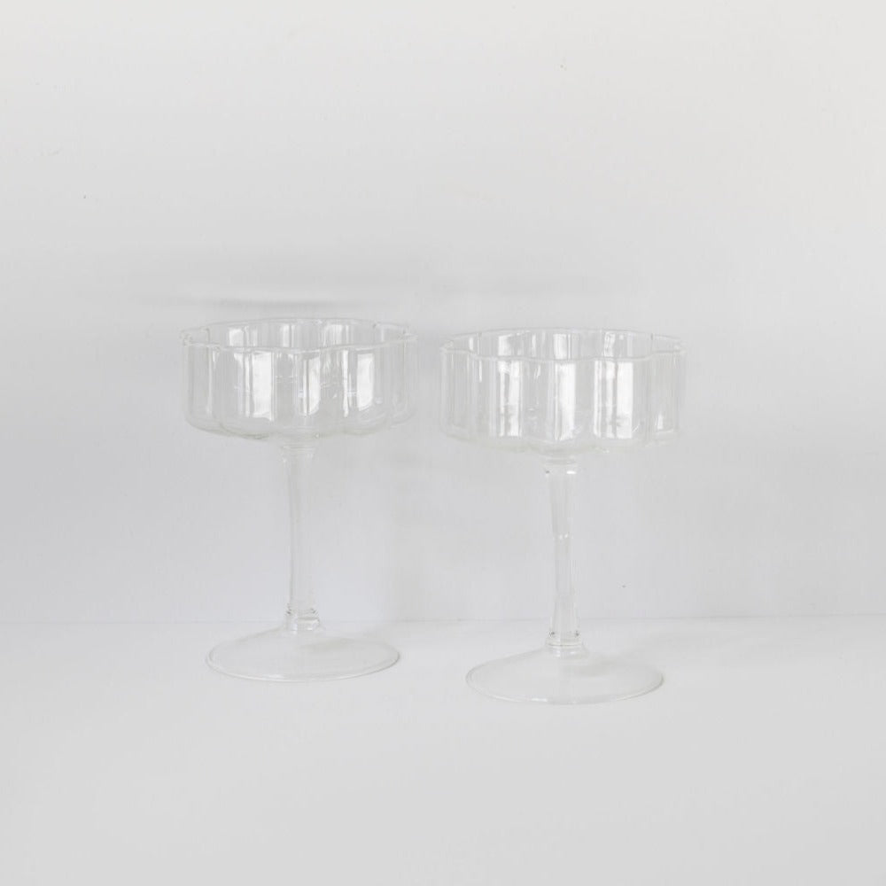 A set of two Fazeek wave coupe glasses on a white surface.