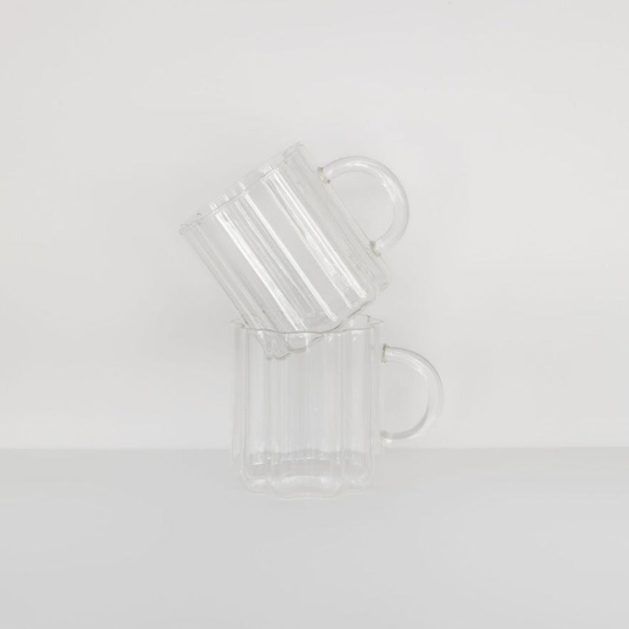Two BigLittleGifting wave mugs, set of two, with vertical ridges, stacked one on top of the other, against a plain white background.