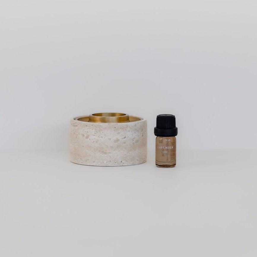 A small asteroid oil burner with a bottle of Addition Studio essential oil next to it.