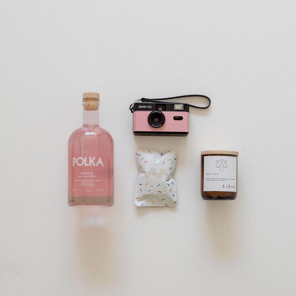 A pink camera from biglittlegifting, a bottle of gin from biglittlegifting and a candle from biglittlegifting.