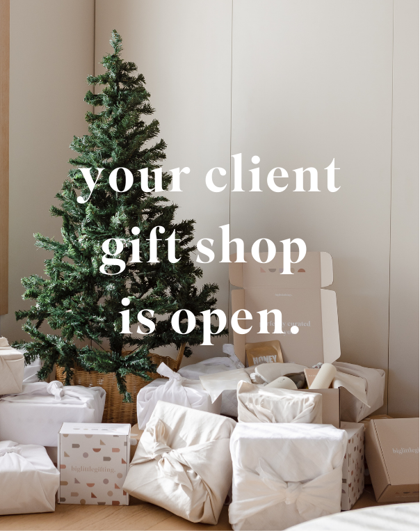 Adorn an artificial Christmas tree with wrapped gifts and boxes to capture the holiday spirit. Text overlay reads, "Your client gift shop is open." Discover the "curate your own client gifting" bundle page by biglittlegifting, crafted with the Bundle Builder app to create a magical holiday shopping experience.