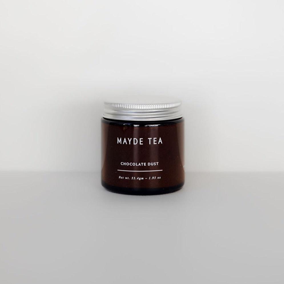 A jar of antioxidant-rich Mayde Tea's "chocolate dust" on a white background.