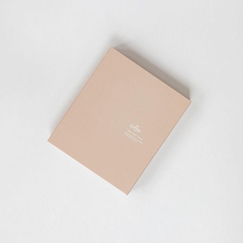 A coffee-colored hardcover journal sitting on top of a white surface. (Brand Name: Emma Kate Co)