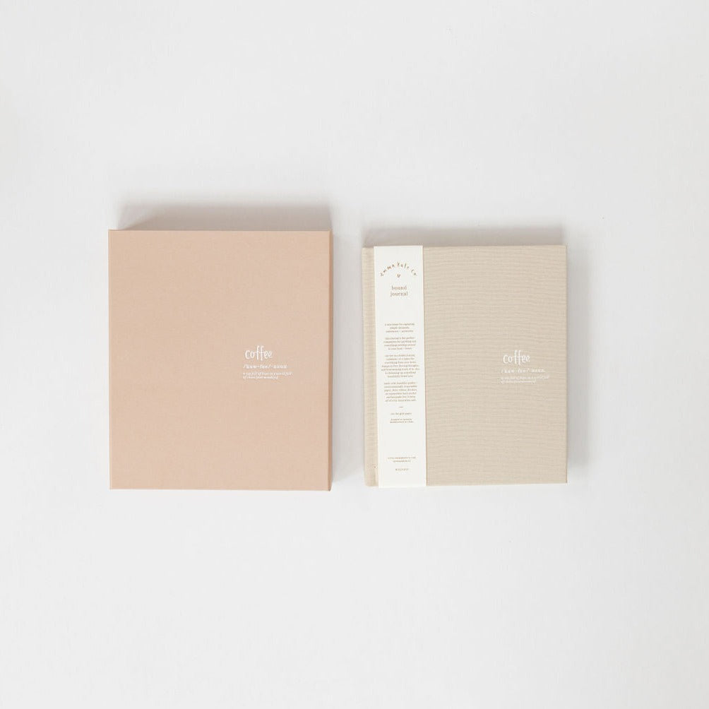 A coffee-colored and beige Emma Kate Co hardcover journal on a white surface.