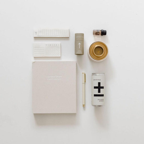 A practical and luxurious client gift displaying the Entrepreneur Vibes notebook, pen, and other items on a white surface. Brand: BigLittleGifting.