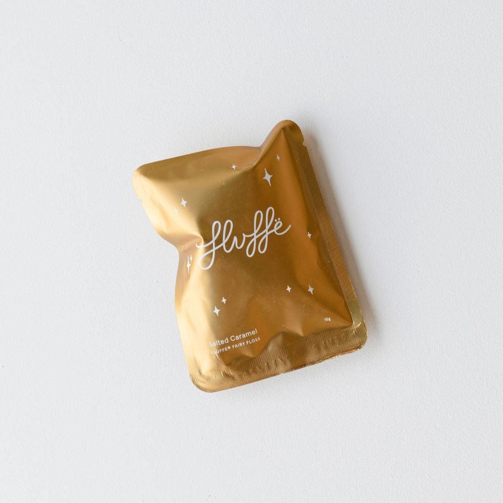 A vegan Fluffe gold foil packet with the word fluff on it, offering a salted caramel taste.