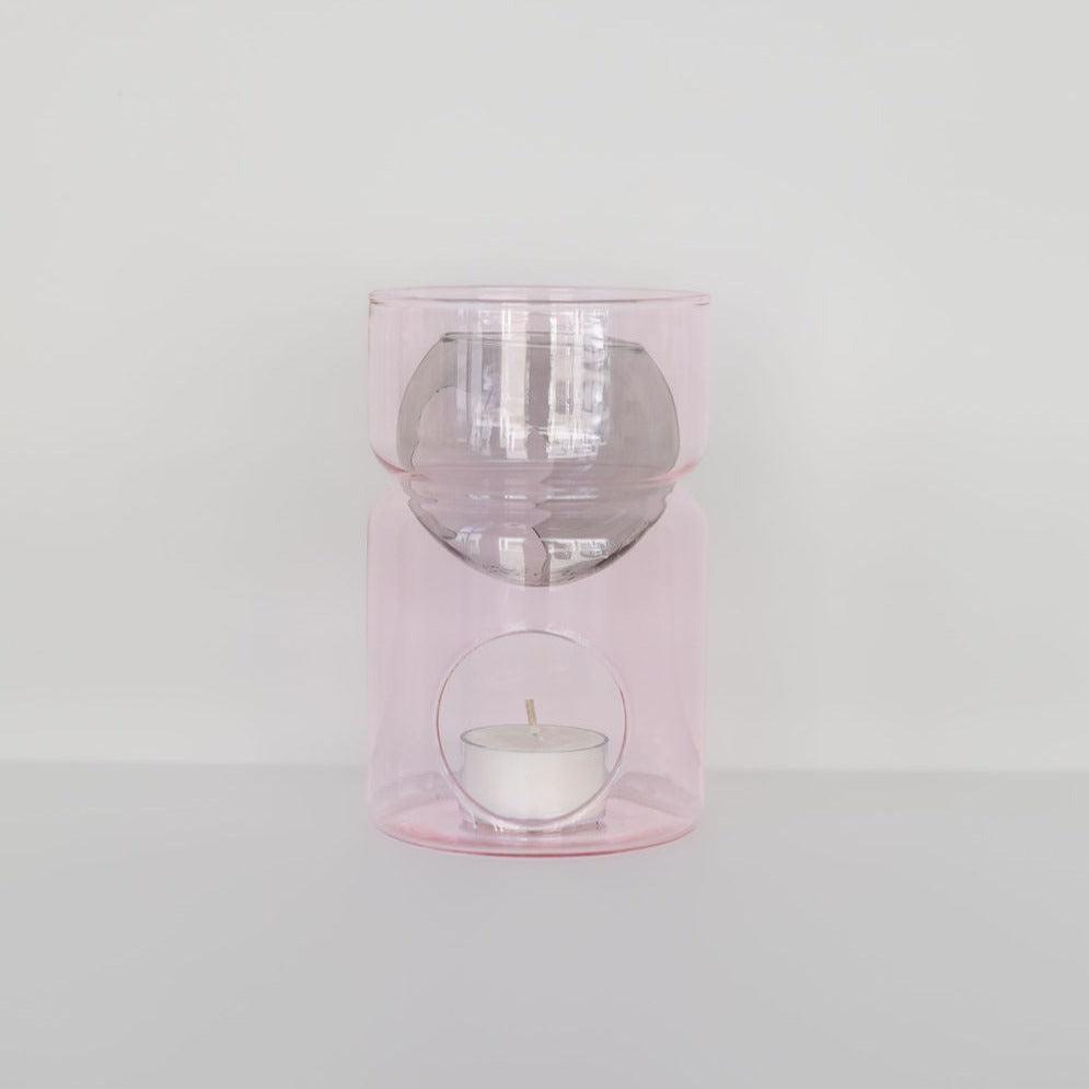 FAZEEK glass oil burner | pink & smoke with a transparent pink glass design, featuring a soy tealight candle holder at the base and a bowl above for essential oil.