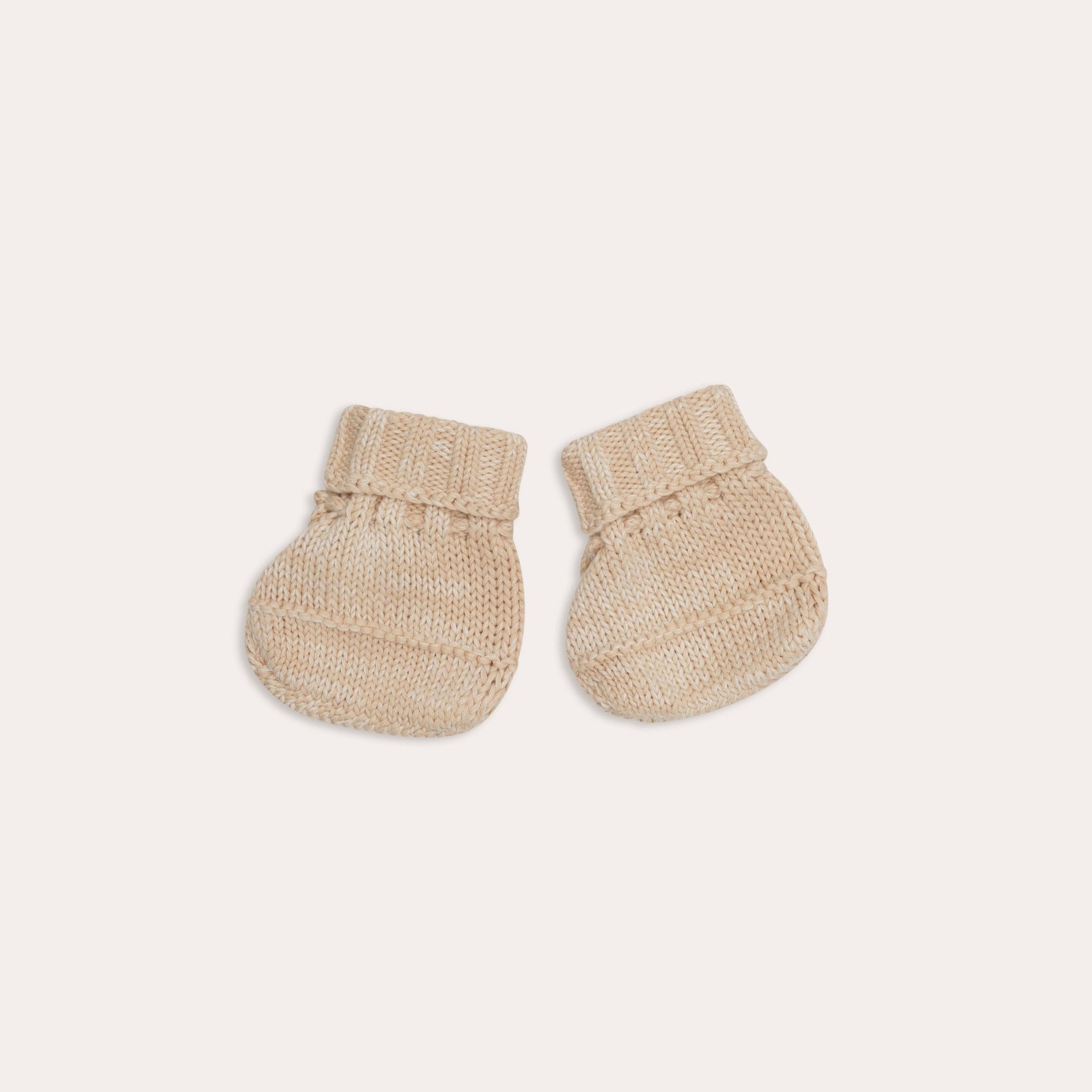 A pair of Illoura the Label illoura knitted alba booties | sand on a white background.