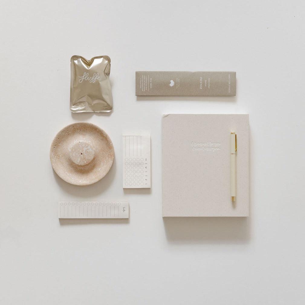 A journaling down time by biglittlegifting, pen, and other items are laid out on a white surface.