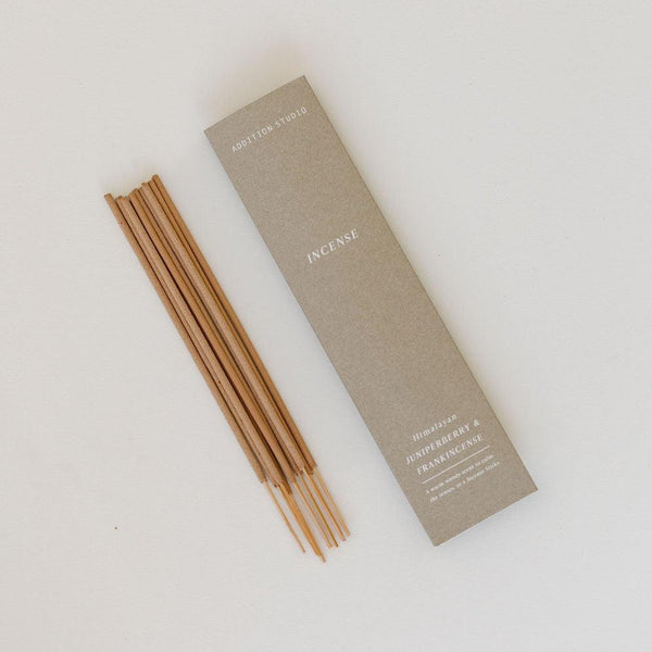 An Addition Studio juniperberry & frankincense incense stick and a box on a white surface.