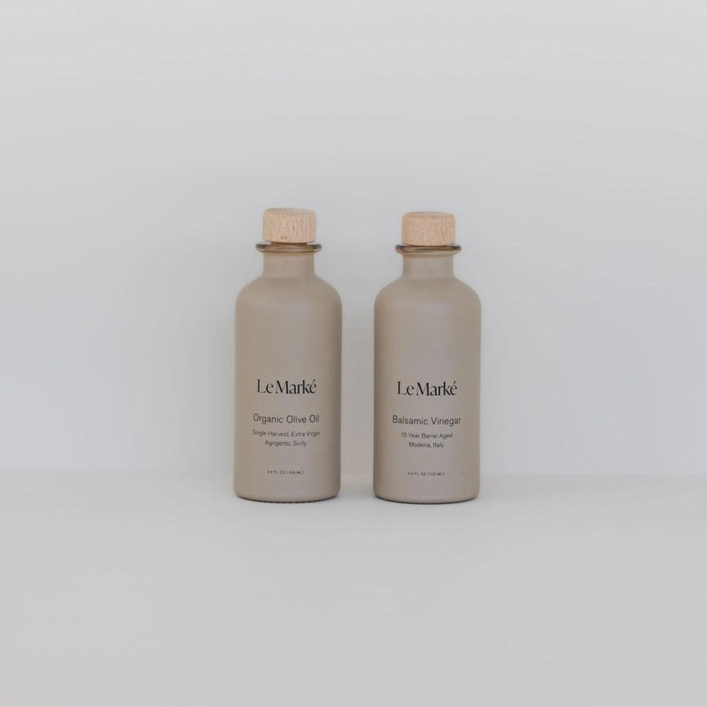 Two bottles of Le Marké tavola set on a white background.