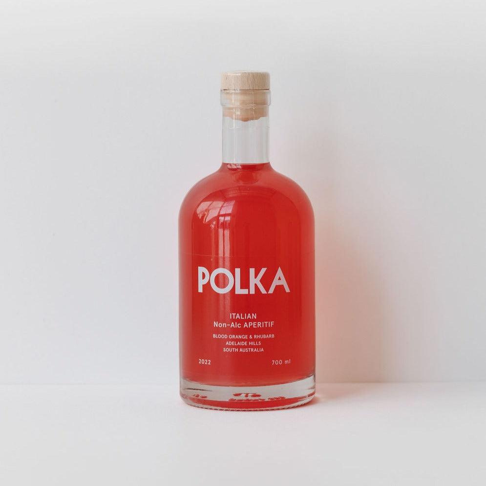 A bottle of Polka Italian non-alcoholic aperitif, red in color, labeled with details, against a white background.