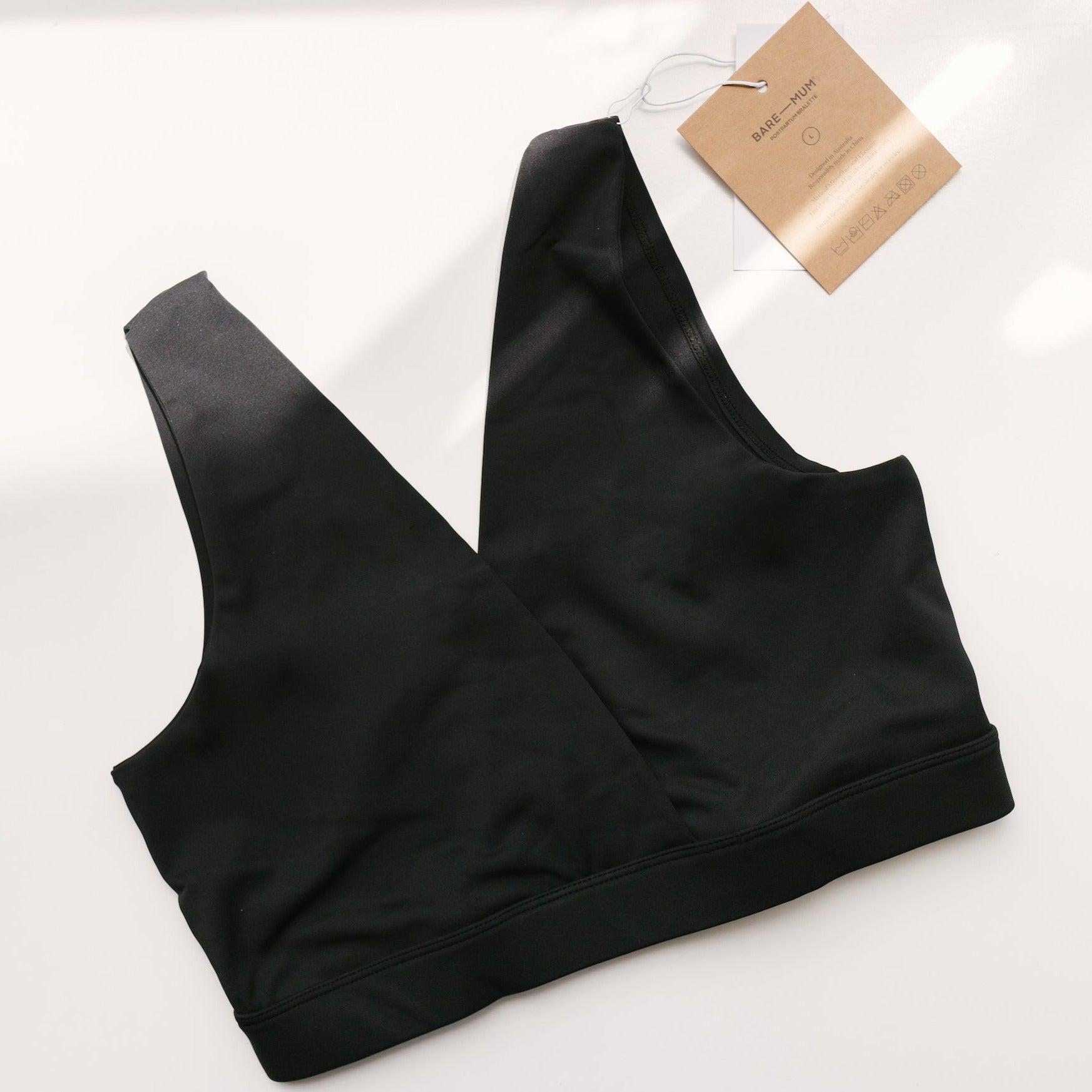 A black Postpartum Bralette from Bare Mum with a tag on it.