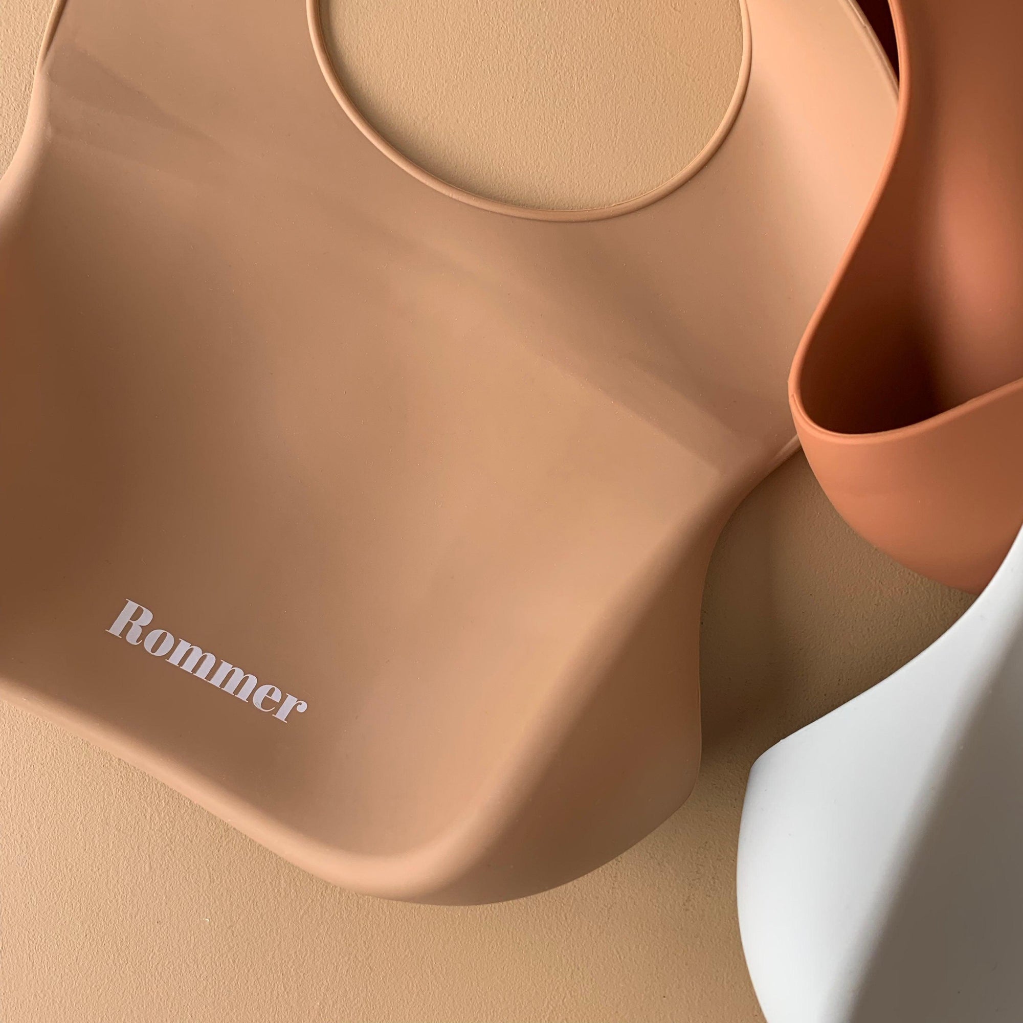 Rommer bibs are made from the softest silicone. They are both lightweight and durable. Rommer has updated the bib design to feature the reinforced button holes making them more resistant to tears. 