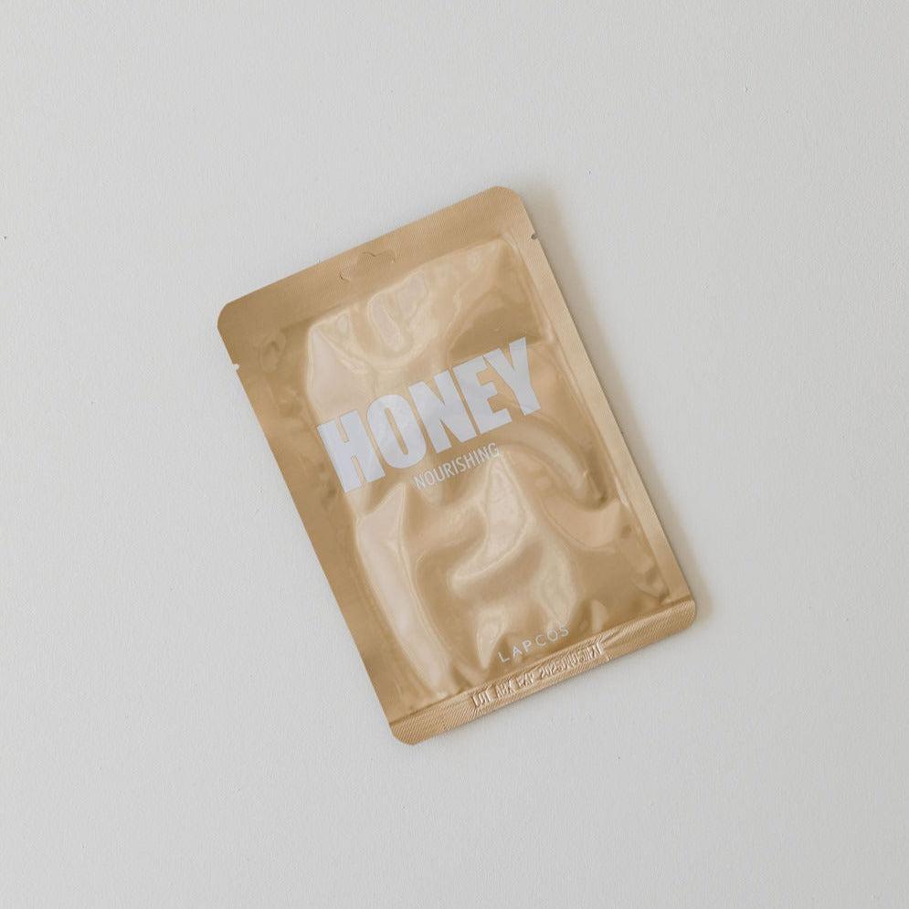A packet of Lapcos nourishing sheet face mask on a white surface.