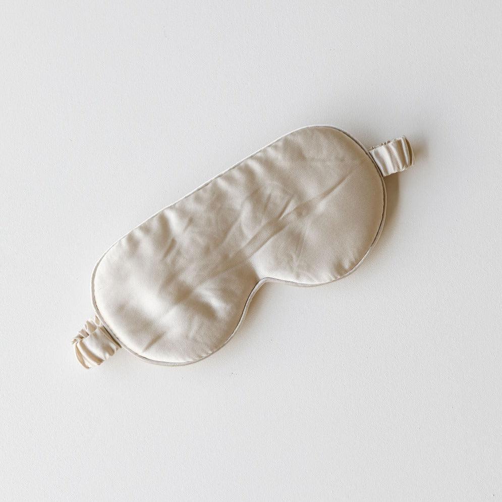 A champagne silk eye mask from The Silk Collection on a plain white background.