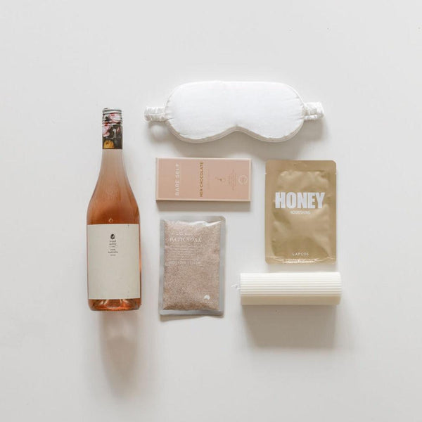 A bottle of the big relax wine and other items are laid out on a white surface.