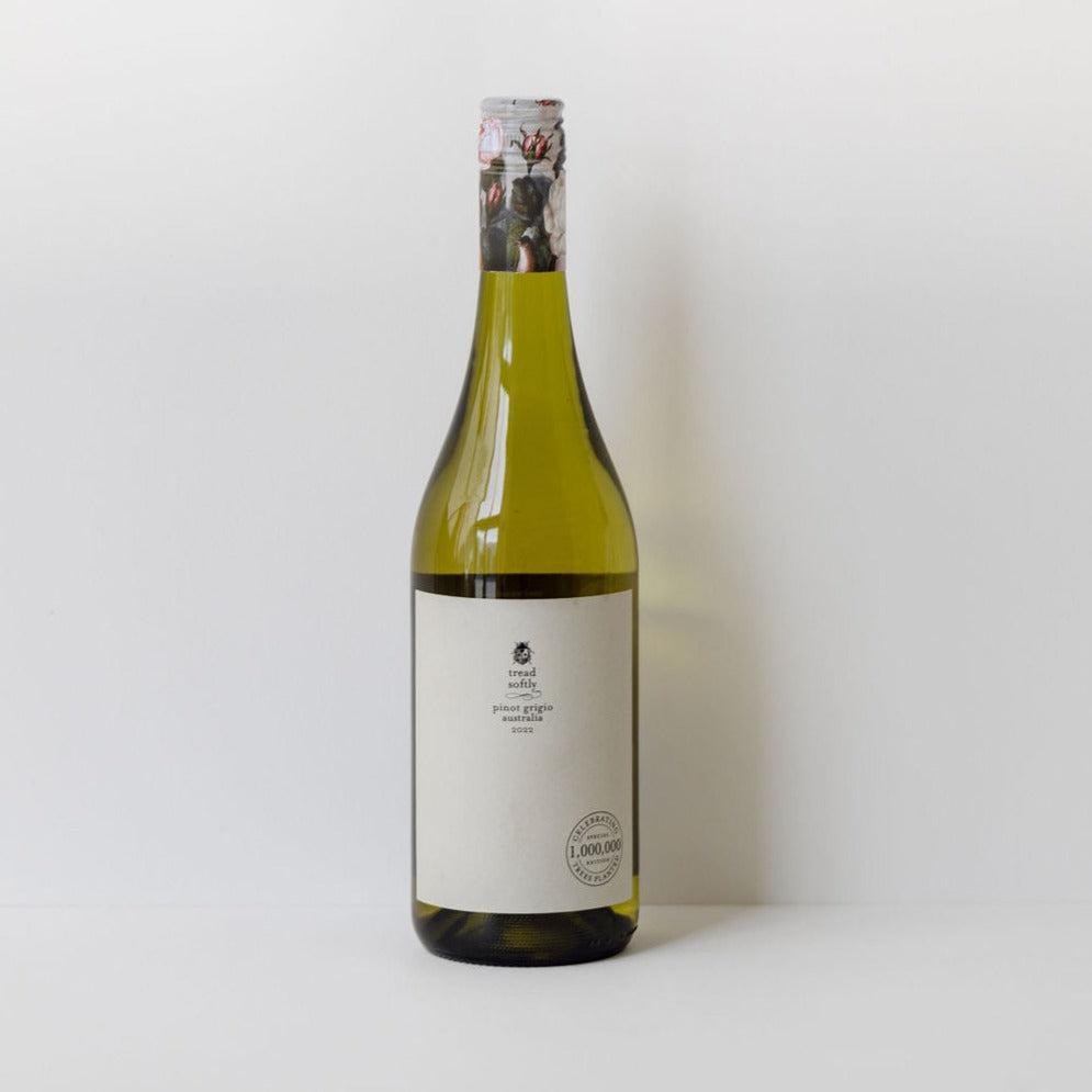 A bottle of Tread Softly Pinot Grigio on a sustainable vineyard management background.