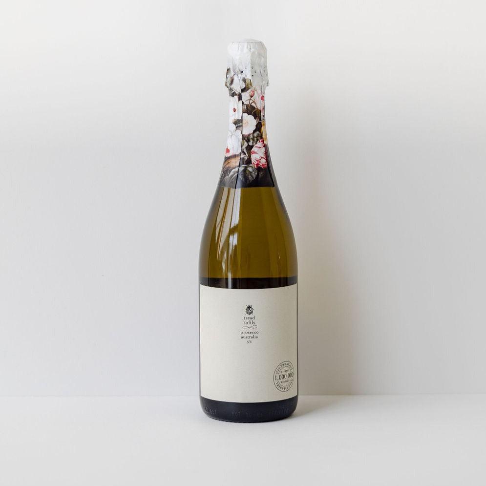 A bottle of Tread Softly prosecco sitting on a white surface.