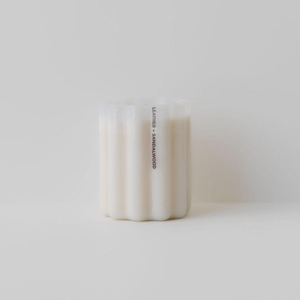 A white, four-wick wave candle labeled "good things will happen" made of natural soy wax, against a plain, light background. Brand name: Fazeek