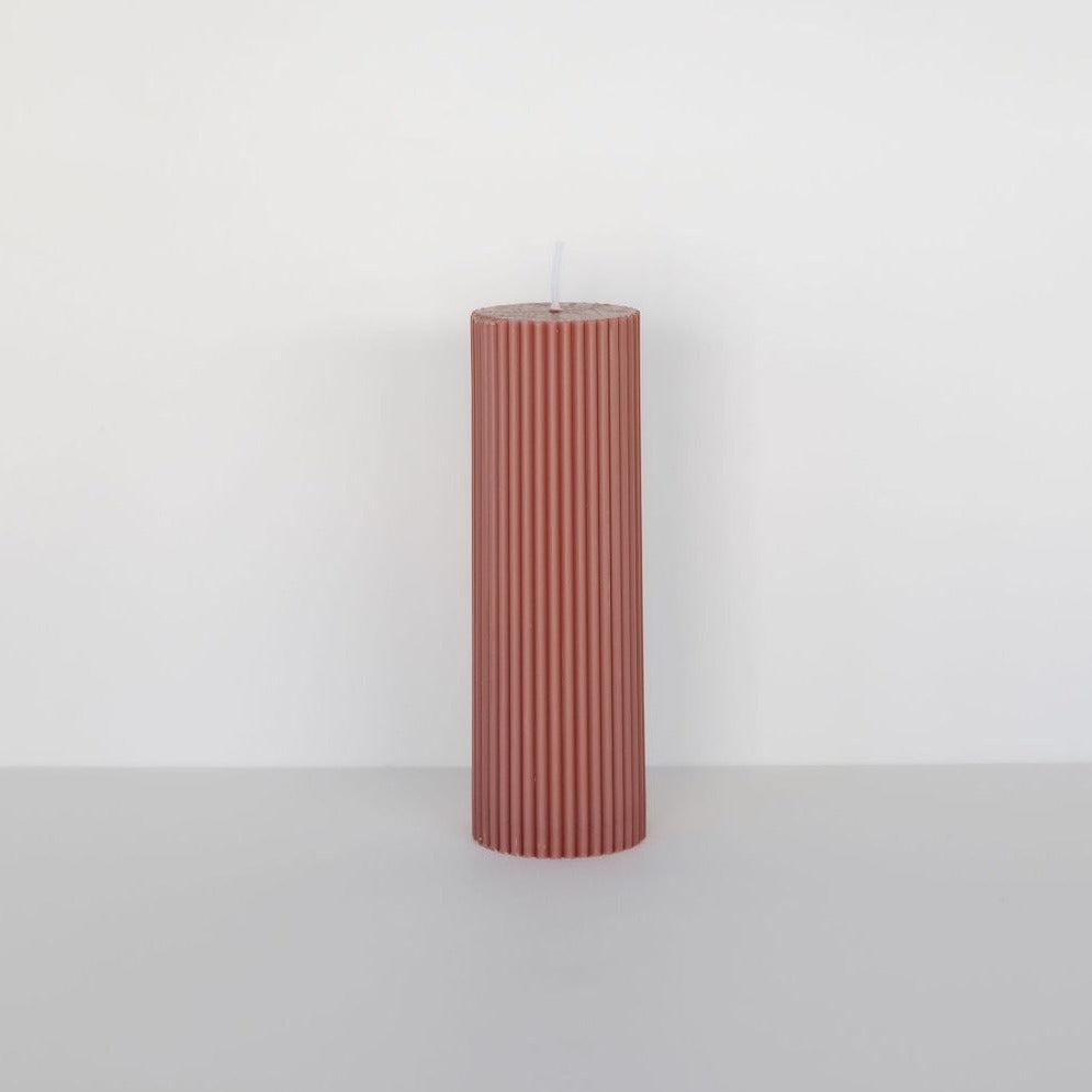 A Black Blaze wide column pillar candle with a pink stripe on a white background.