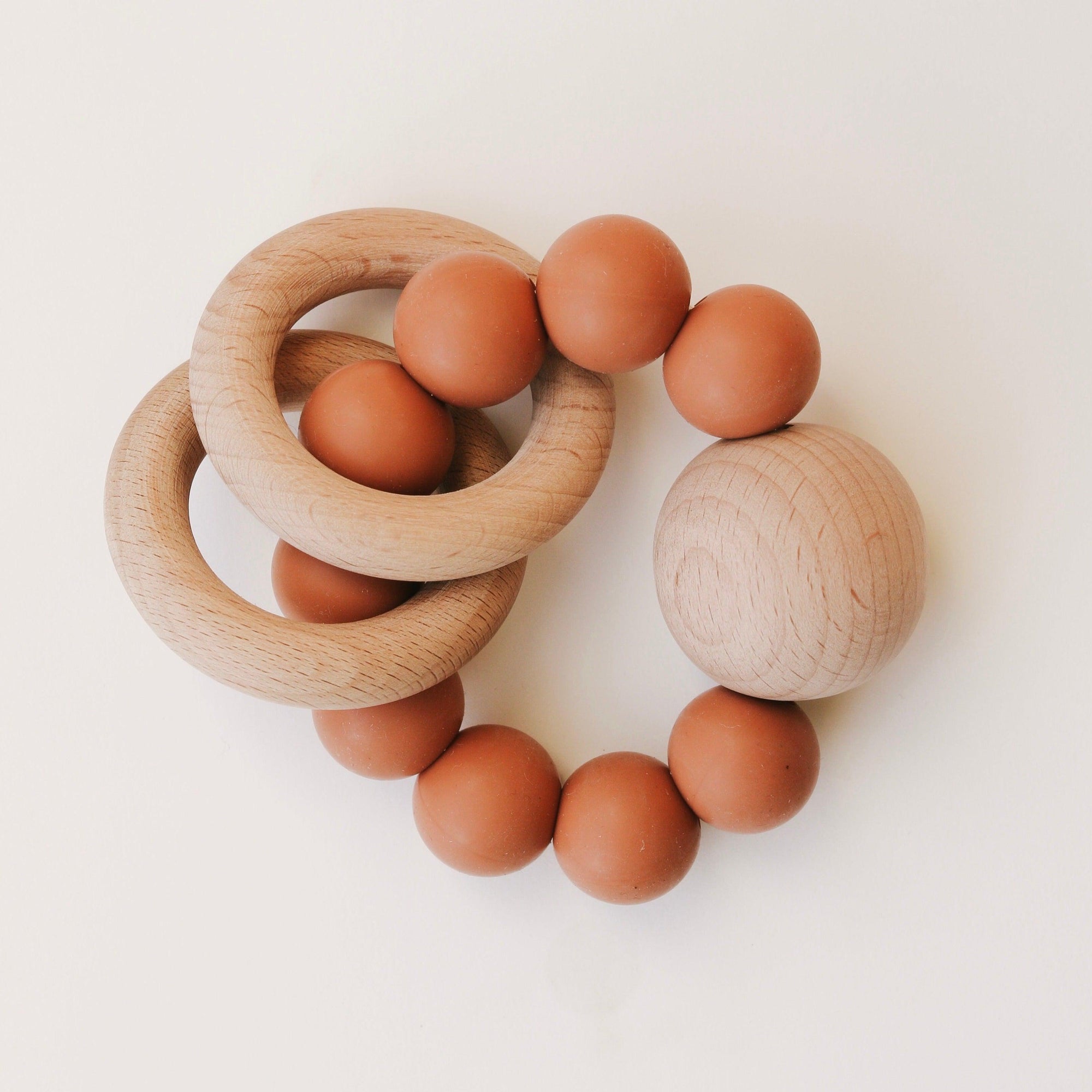 Wooden Silicone Teether by Dove & Dovelet with BPA free silicone beads on a white background.