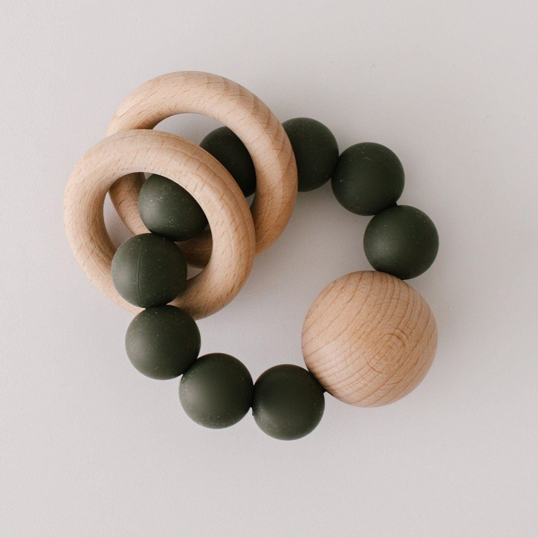 Wooden Silicone Teether with BPA-free silicone beads and teething rings on a light background by Dove & Dovelet.