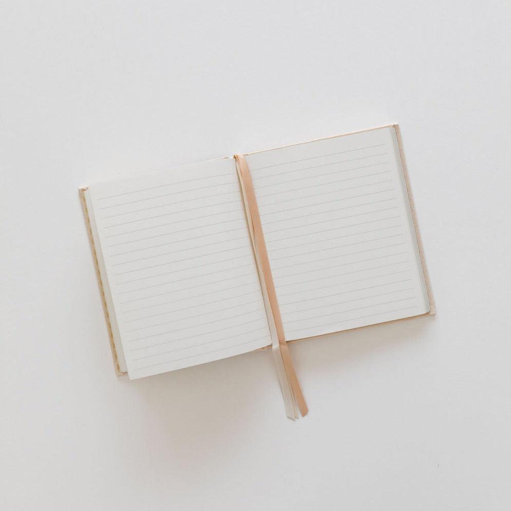 An Emma Kate Co hardcover journal on a white surface.