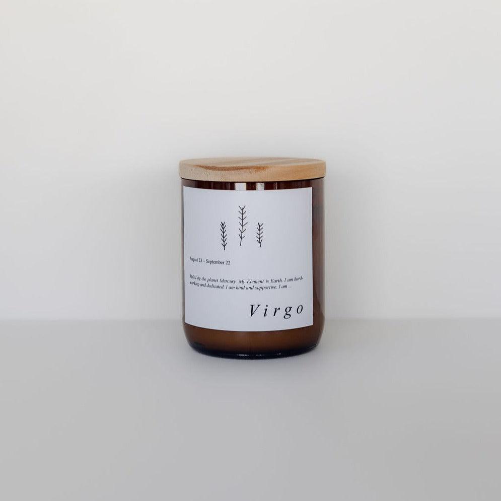 A zodiac candle labeled "virgo" from The Commonfolk Collective's Zodiac Candle Range, featuring a simple design, crafted with soy candle wax, set against a plain white background.